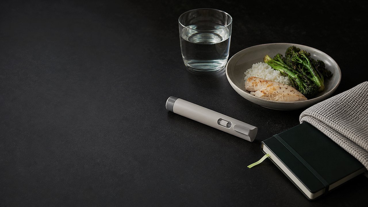 An unbranded injection pen, water, meal and symptom diary with responsive digestive-health labels